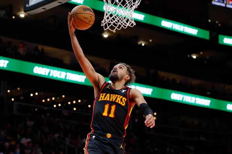 ATLANTA, GEORGIA - DECEMBER 08: Trae Young #11 of the Atlanta Hawks goes up for a shot during the fourth quarter against the Denver Nuggets at State Farm Arena on December 8, 2024 in Atlanta, Georgia. NOTE TO USER: User expressly acknowledges and agrees that, by downloading and or using this photograph, User is consenting to the terms and conditions of the Getty Images License Agreement. (Photo by Todd Kirkland/Getty Images)