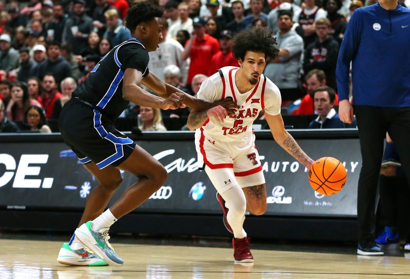 Jan 20, 2024; Lubbock, Texas, USA;  Texas Tech Red Raiders guard Pop Isaacs (2) drives the ball against Brigham Young Cougars guard Jaxson Robinson (2) in the second half at United Supermarkets Arena. Mandatory Credit: Michael C. Johnson-USA TODAY Sports