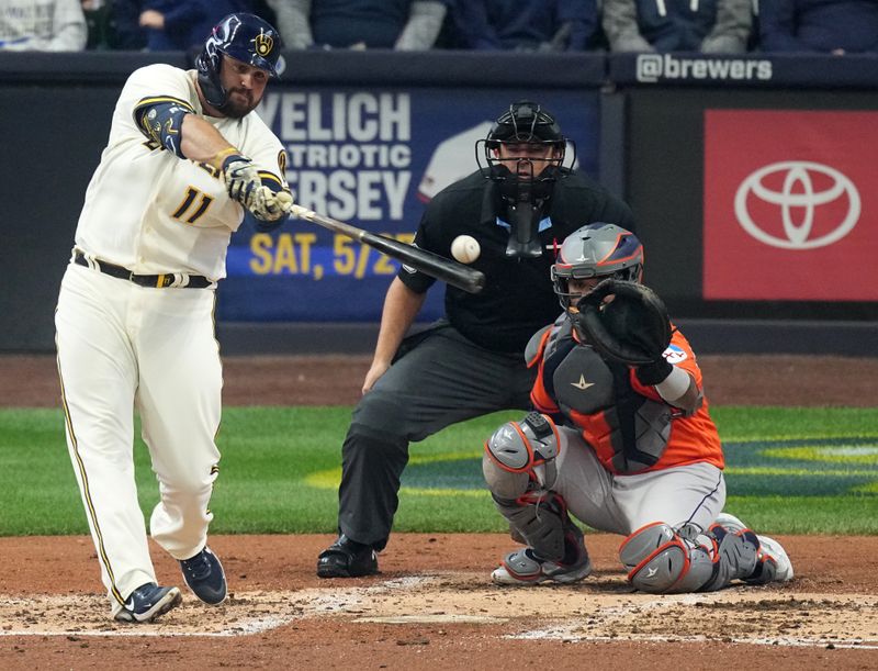 May 24, 2023; Milwaukee, Wisconsin, USA; Milwaukee Brewers first baseman Rowdy Tellez (11) hits a single during the fourth inning of their game against the Houston Astros at American Family Field. Mandatory Credit: Mark Hoffman-USA TODAY Sports