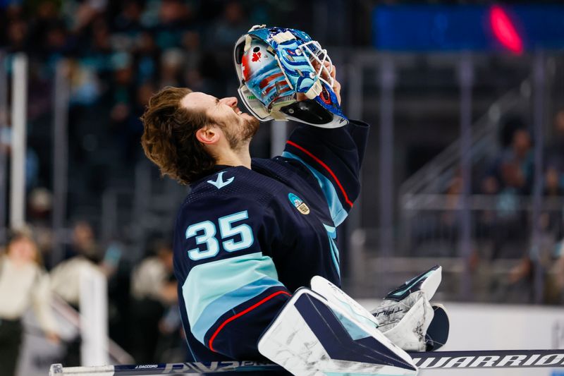 Jan 4, 2024; Seattle, Washington, USA; Seattle Kraken goaltender Joey Daccord (35) puts his helmet back on following a third period timeout against the Ottawa Senators at Climate Pledge Arena. Mandatory Credit: Joe Nicholson-USA TODAY Sports