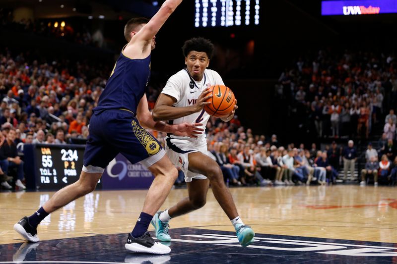 Feb 18, 2023; Charlottesville, Virginia, USA; Virginia Cavaliers guard Reece Beekman (2) controls the ball as Notre Dame Fighting Irish forward Nate Laszewski (14) defends during the second half at John Paul Jones Arena. Mandatory Credit: Amber Searls-USA TODAY Sports