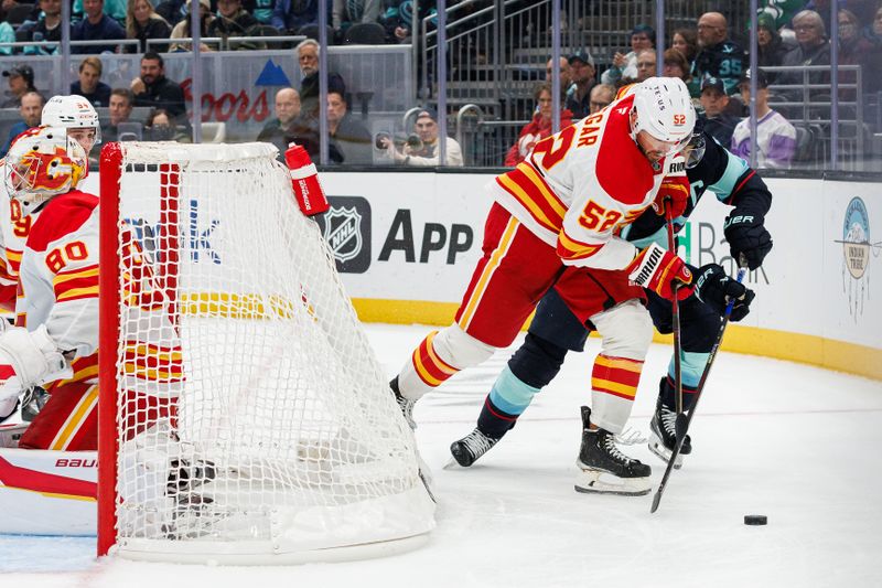 Oct 19, 2024; Seattle, Washington, USA; Calgary Flames defenseman MacKenzie Weegar (52) skates against Seattle Kraken right wing Jordan Eberle (7) during the third period at Climate Pledge Arena. Mandatory Credit: Caean Couto-Imagn Images