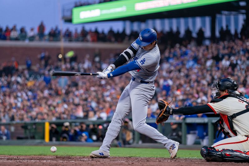 May 13, 2024; San Francisco, California, USA; Los Angeles Dodgers designated hitter Shohei Ohtani (17) hits a RBI single against the San Francisco Giants during the fifth inning at Oracle Park. Mandatory Credit: Neville E. Guard-USA TODAY Sports