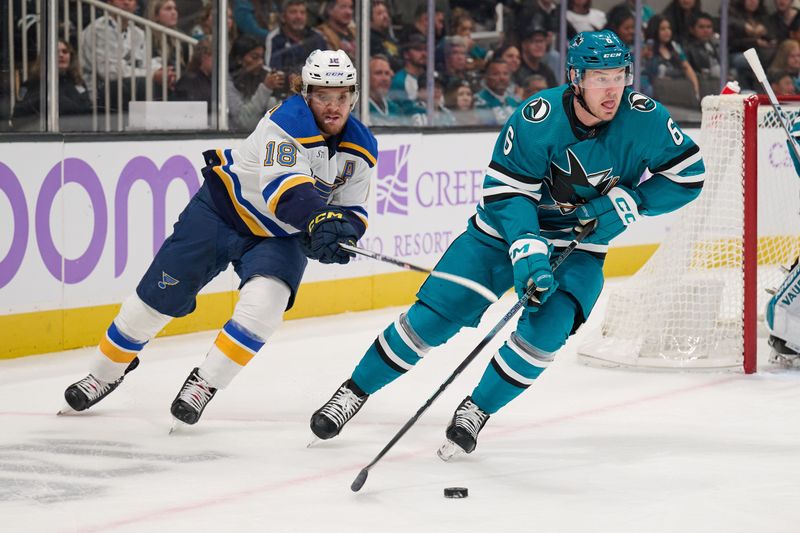 Nov 16, 2023; San Jose, California, USA; San Jose Sharks defenseman Ty Emberson (6) skates with the puck against St. Louis Blues center Robert Thomas (18) during the first period at SAP Center at San Jose. Mandatory Credit: Robert Edwards-USA TODAY Sports