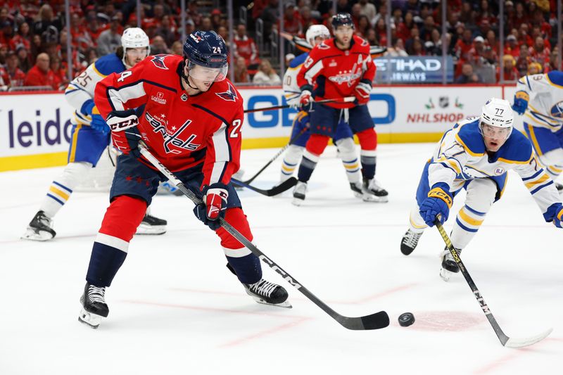 Nov 22, 2023; Washington, District of Columbia, USA; Washington Capitals center Connor McMichael (24) controls the puck as Buffalo Sabres right wing JJ Peterka (77) defends in the first period at Capital One Arena. Mandatory Credit: Geoff Burke-USA TODAY Sports