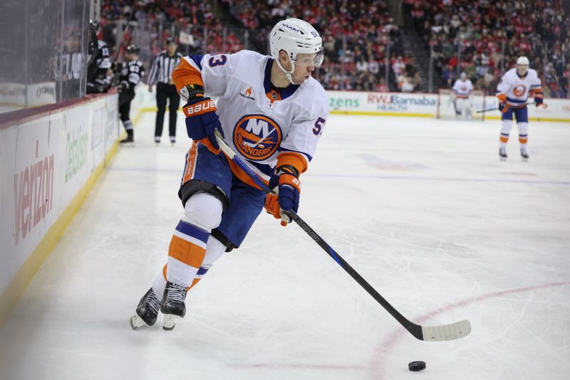 Apr 13, 2025; Newark, New Jersey, USA; New York Islanders center Casey Cizikas (53) skates with the puck against the New Jersey Devils during the third period at Prudential Center. Mandatory Credit: Ed Mulholland-Imagn Images