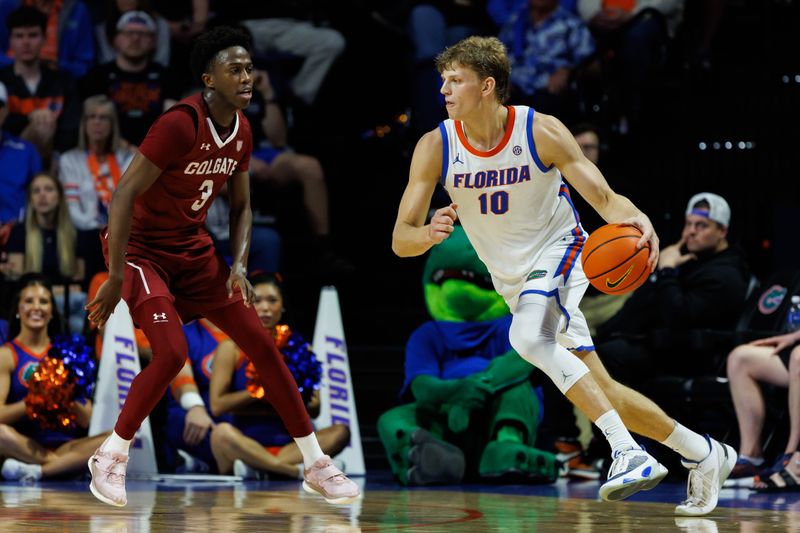 Dec 21, 2025; Gainesville, Florida, USA; Florida Gators forward Thomas Haugh (10) dribbles the ball while Colgate Raiders guard Jalen Cox (3) defends during the first half at Exactech Arena at the Stephen C. O'Connell Center. Mandatory Credit: Matt Pendleton-Imagn Images