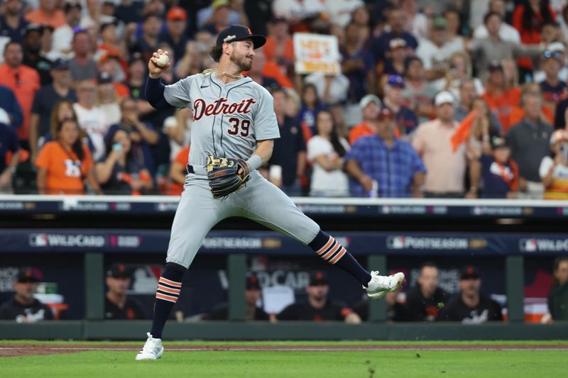 Oct 2, 2024; Houston, Texas, USA; Detroit Tigers shortstop Zach McKinstry (39) fields a bunt single by Houston Astros outfielder Mauricio Dubon (not pictured) during the seventh inning of game two of the Wildcard round for the 2024 MLB Playoffs at Minute Maid Park. Mandatory Credit: Thomas Shea-Imagn Images