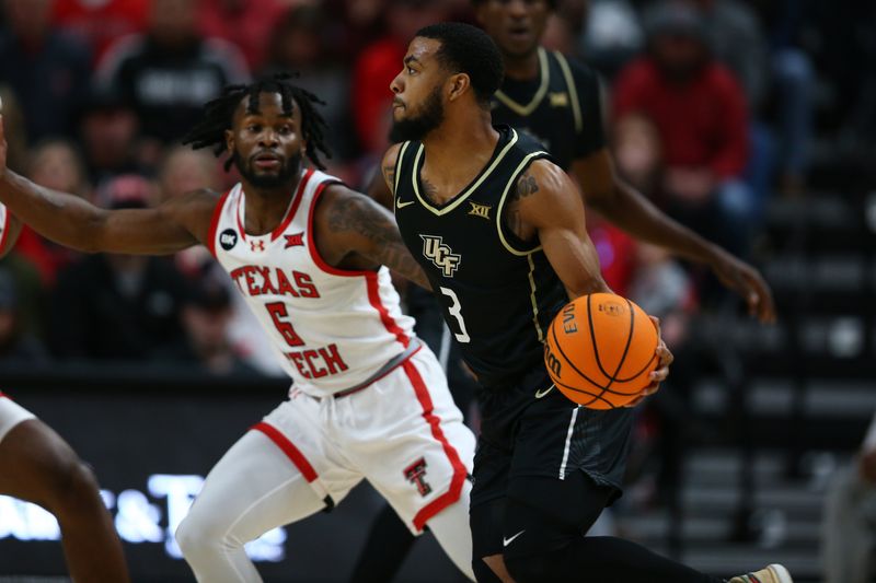 Feb 10, 2024; Lubbock, Texas, USA;  Central Florida Knights guard Darius Johnson (3) dribbles the ball against Texas Tech Red Raiders guard Joe Toussaint (6) in the first half United Supermarkets Arena. Mandatory Credit: Michael C. Johnson-USA TODAY Sports