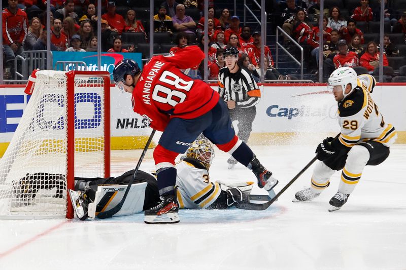 Oct 5, 2024; Washington, District of Columbia, USA; Boston Bruins goaltender Brandon Bussi (30) makes a save on Washington Capitals left wing Andrew Mangiapane (88) in the third period at Capital One Arena. Mandatory Credit: Geoff Burke-Imagn Images