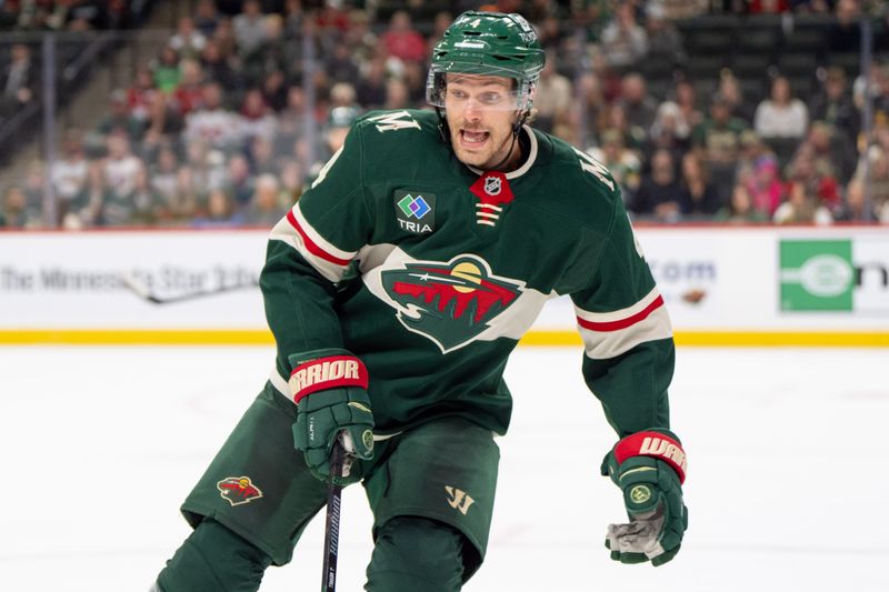 Nov 14, 2024; Saint Paul, Minnesota, USA; Minnesota Wild defenseman Jon Merrill (4) retrieves the puck in the Wild zone against the Montreal Canadiens in the third period at Xcel Energy Center. Mandatory Credit: Matt Blewett-Imagn Images