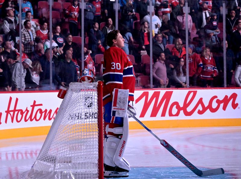 Sep 23, 2024; Montreal, Quebec, CAN; Montreal Canadiens goalie Cayden Primeau (30) during the 13 seconds of silence in honor of the Gaudreau brothers before a game against the Philadelphia Flyers at the Bell Centre. Mandatory Credit: Eric Bolte-Imagn Images