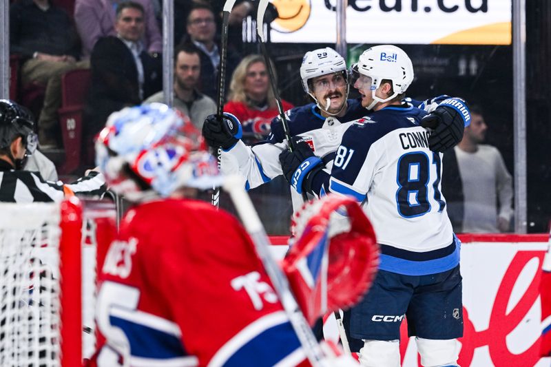 Dec 3, 2025; Montreal, Quebec, CAN; Winnipeg Jets left wing Kyle Connor (81) celebrates with center Mark Scheifele (55) after a goal against Montreal Canadiens goalie Jakub Dobes (75) during the second period at Bell Centre. Mandatory Credit: David Kirouac-Imagn Images