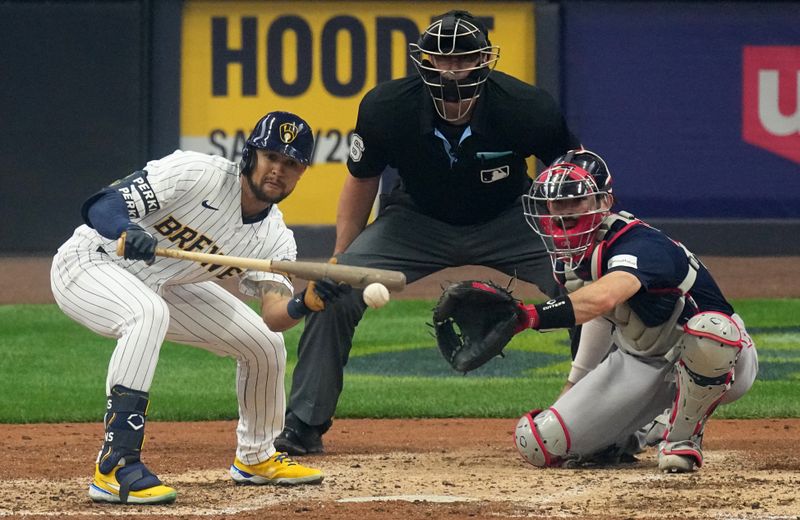 Apr 23, 2023; Milwaukee, Wisconsin, USA; Milwaukee Brewers center fielder Blake Perkins (16) lays down a bunt during the fifth inning of their game against the Boston Red Sox at American Family Field. Mandatory Credit: Mark Hoffman-USA TODAY Sports