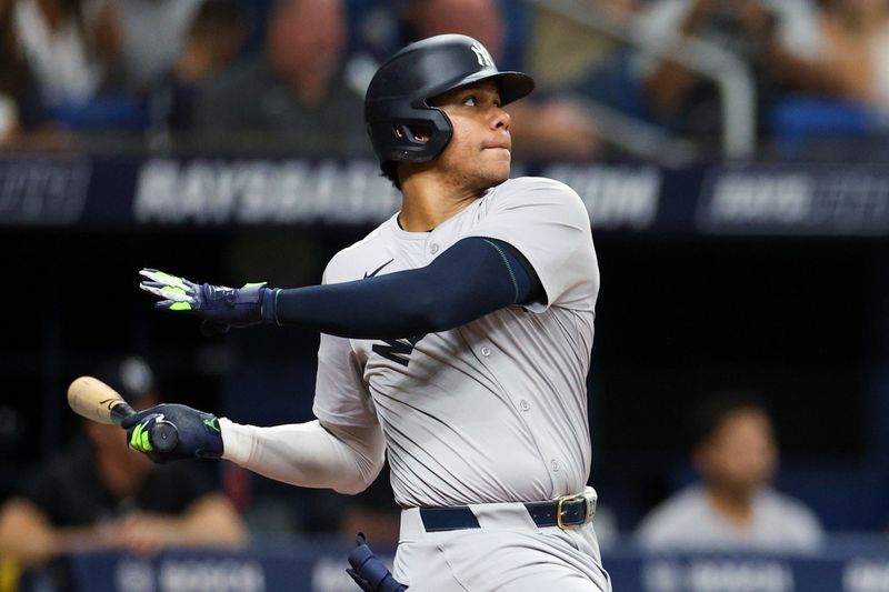 Jul 11, 2024; St. Petersburg, Florida, USA;  New York Yankees outfielder Juan Soto (22) hits a solo home run against the Tampa Bay Rays in the third inning at Tropicana Field. Mandatory Credit: Nathan Ray Seebeck-USA TODAY Sports