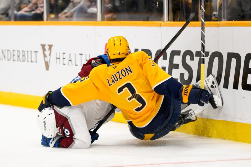 Nov 2, 2024; Nashville, Tennessee, USA;  Colorado Avalanche right wing Mikko Rantanen (96) and Nashville Predators defenseman Jeremy Lauzon (3) collide during the second period at Bridgestone Arena. Mandatory Credit: Steve Roberts-Imagn Images