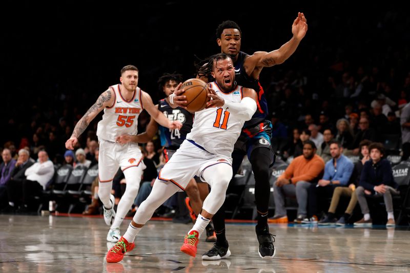 NEW YORK, NEW YORK - DECEMBER 20: Jalen Brunson #11 of the New York Knicks dribbles as Nic Claxton #33 of the Brooklyn Nets defends during the second half at Barclays Center on December 20, 2023 in the Brooklyn borough of New York City. The Knicks won 121-102. NOTE TO USER: User expressly acknowledges and agrees that, by downloading and/or using this Photograph, user is consenting to the terms and conditions of the Getty Images License Agreement. (Photo by Sarah Stier/Getty Images)