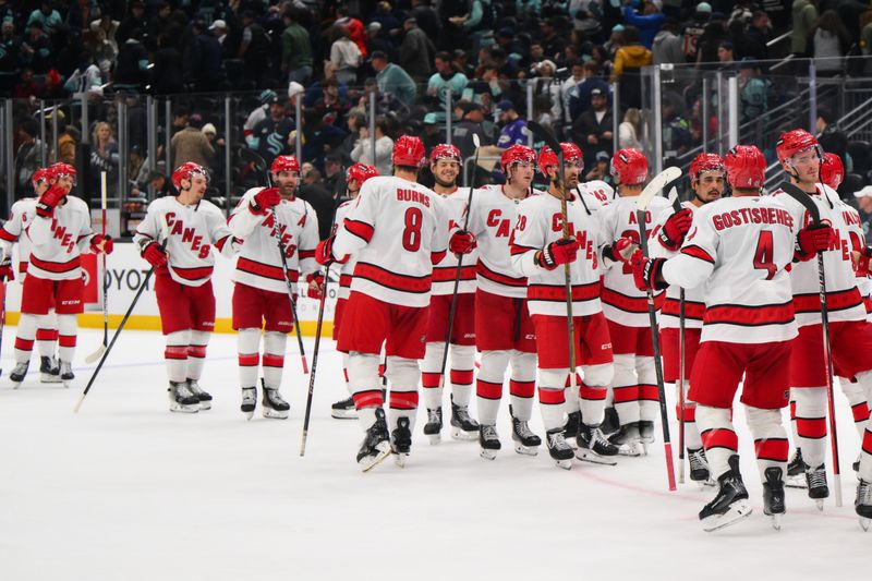 Oct 26, 2024; Seattle, Washington, USA; The Carolina Hurricanes celebrate defeating the Seattle Kraken at Climate Pledge Arena. Mandatory Credit: Steven Bisig-Imagn Images