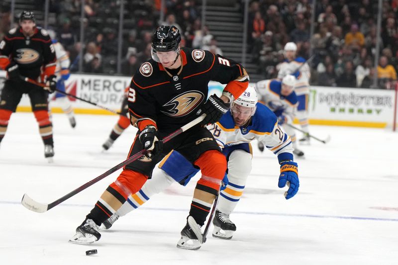 Feb 15, 2023; Anaheim, California, USA; Anaheim Ducks defenseman John Klingberg (3) and Buffalo Sabres left wing Zemgus Girgensons (28) battle for the puck in the first period  at Honda Center. Mandatory Credit: Kirby Lee-USA TODAY Sports