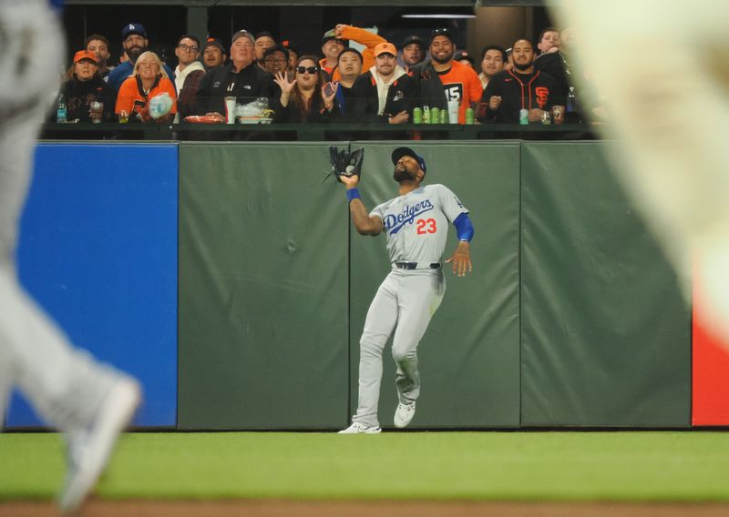 Jun 28, 2024; San Francisco, California, USA; Los Angeles Dodgers right fielder Jason Heyward (23) makes a catch against the San Francisco Giants during the sixth inning at Oracle Park. Mandatory Credit: Kelley L Cox-USA TODAY Sports