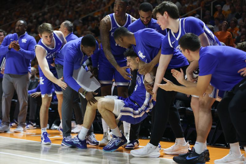 Jan 28, 2025; Knoxville, Tennessee, USA; Kentucky Wildcats guard Koby Brea (4) is helped off the floor by teammates during the second half against the Tennessee Volunteers at Thompson-Boling Arena at Food City Center. Mandatory Credit: Randy Sartin-Imagn Images