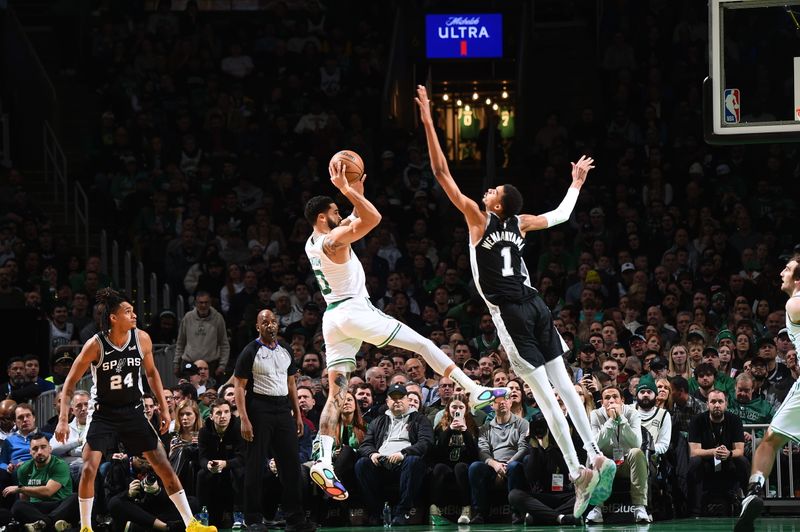 BOSTON, MA - JANUARY 17: Jayson Tatum #0 of the Boston Celtics passes the ball against defender Victor Wembanyama #1 of the San Antonio Spurs during the game on January 17, 2024 at the TD Garden in Boston, Massachusetts. NOTE TO USER: User expressly acknowledges and agrees that, by downloading and or using this photograph, User is consenting to the terms and conditions of the Getty Images License Agreement. Mandatory Copyright Notice: Copyright 2024 NBAE  (Photo by Brian Babineau/NBAE via Getty Images)