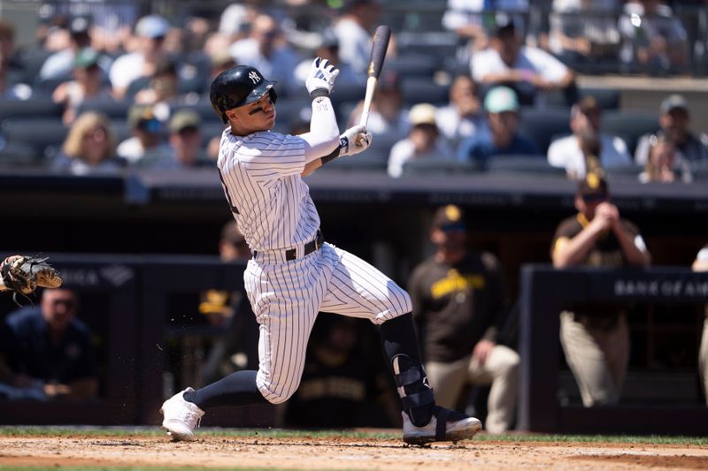 May 28, 2023; Bronx, New York, USA; New York Yankees shortstop Anthony Volpe (11) hits an RBI single against the San Diego Padres during the third inning at Yankee Stadium. Mandatory Credit: Gregory Fisher-USA TODAY Sports