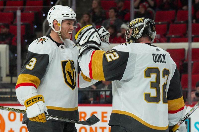 Mar 11, 2023; Raleigh, North Carolina, USA; Vegas Golden Knights goaltender Jonathan Quick (32) and defenseman Brayden McNabb (3) celebrate their victory against the Carolina Hurricanes at PNC Arena. Mandatory Credit: James Guillory-USA TODAY Sports