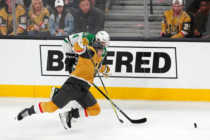 May 3, 2024; Las Vegas, Nevada, USA; Vegas Golden Knights center William Karlsson (71) is tripped by Dallas Stars defenseman Miro Heiskanen (4) during the third period of game six of the first round of the 2024 Stanley Cup Playoffs at T-Mobile Arena. Mandatory Credit: Stephen R. Sylvanie-USA TODAY Sports