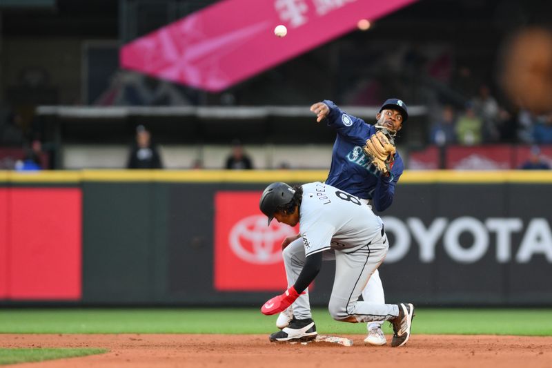 Jun 11, 2024; Seattle, Washington, USA; Seattle Mariners second baseman Ryan Bliss (1) throws the ball over Chicago White Sox second baseman Nicky Lopez (8) to complete a double play during the sixth inning at T-Mobile Park. Mandatory Credit: Steven Bisig-USA TODAY Sports