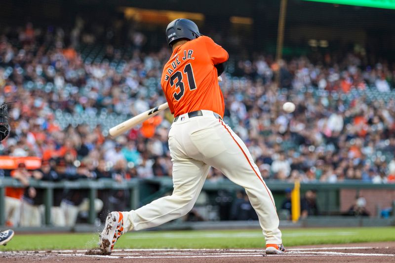 Jul 12, 2024; San Francisco, California, USA; San Francisco Giants first baseman LaMonte Wade Jr. (31) hits a sacrifice fly for an RBI against the Minnesota Twins during the first inning at Oracle Park. Mandatory Credit: John Hefti-USA TODAY Sports