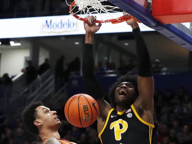 Feb 24, 2024; Pittsburgh, Pennsylvania, USA;  Pittsburgh Panthers forward Blake Hinson (2) dunks the ball against Virginia Tech Hokies center Lynn Kidd (left) during the first half at the Petersen Events Center. Mandatory Credit: Charles LeClaire-USA TODAY Sports