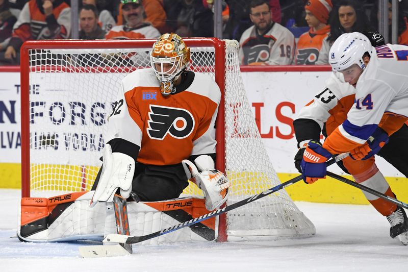 Jan 30, 2025; Philadelphia, Pennsylvania, USA; Philadelphia Flyers goaltender Ivan Fedotov (82) makes a save against New York Islanders center Bo Horvat (14) during the first period at Wells Fargo Center. Mandatory Credit: Eric Hartline-Imagn Images