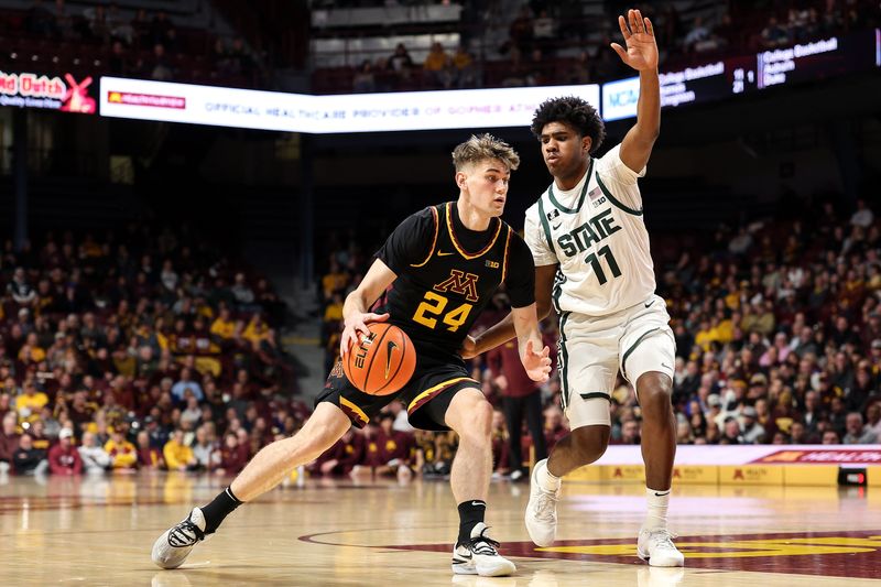 Dec 4, 2024; Minneapolis, Minnesota, USA; Minnesota Golden Gophers guard Brennan Rigsby (24) works around Michigan State Spartans guard Jase Richardson (11) during the first half at Williams Arena. Mandatory Credit: Matt Krohn-Imagn Images