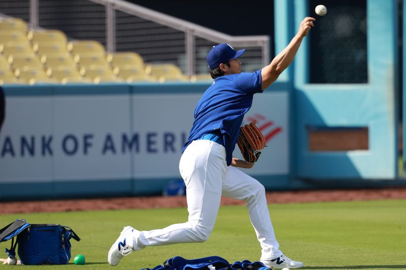 May 3, 2024; Los Angeles, California, USA;  Los Angeles Dodgers two-way player Shohei Ohtani (17) plays a catch before the game against the Atlanta Braves at Dodger Stadium. Mandatory Credit: Kiyoshi Mio-USA TODAY Sports