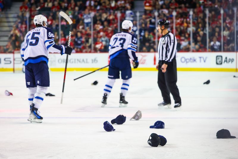 Feb 19, 2024; Calgary, Alberta, CAN; General view of the hats on the ice as Winnipeg Jets center Sean Monahan (23) scores his third goal against the Calgary Flames during the first period at Scotiabank Saddledome. Mandatory Credit: Sergei Belski-USA TODAY Sports