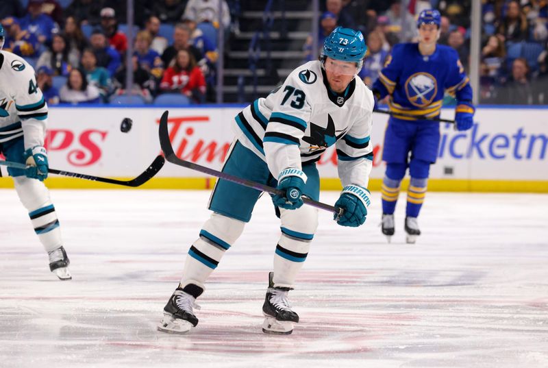 Mar 4, 2025; Buffalo, New York, USA;  San Jose Sharks center Tyler Toffoli (73) flips the puck up ice during the first period against the Buffalo Sabres at KeyBank Center. Mandatory Credit: Timothy T. Ludwig-Imagn Images