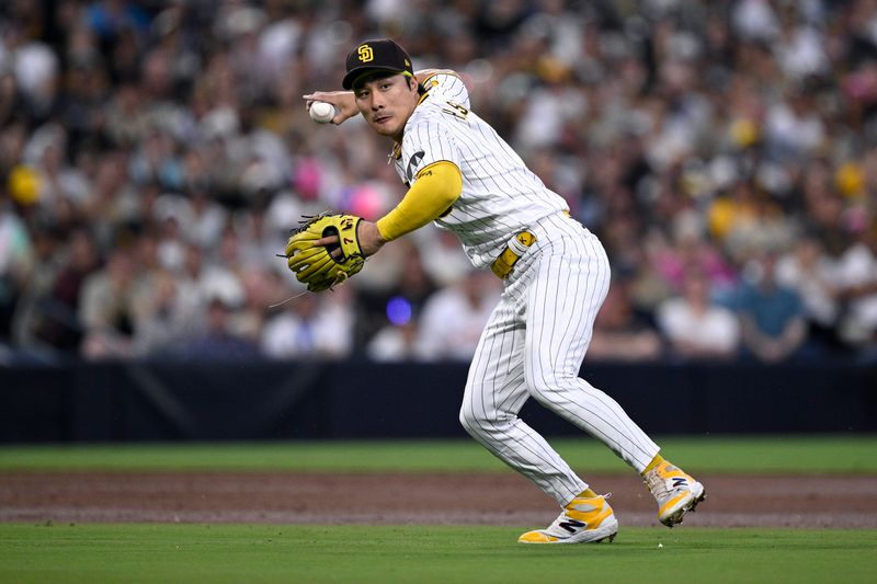 Aug 22, 2023; San Diego, California, USA; San Diego Padres third baseman Ha-seong Kim (7) throws to first base against the Miami Marlins during the third inning at Petco Park. Mandatory Credit: Orlando Ramirez-USA TODAY Sports