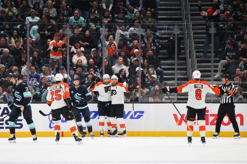 Oct 17, 2024; Seattle, Washington, USA; The Philadelphia Flyers celebrate after a goal scored by center Scott Laughton (21) during the first period against the Seattle Kraken at Climate Pledge Arena. Mandatory Credit: Steven Bisig-Imagn Images