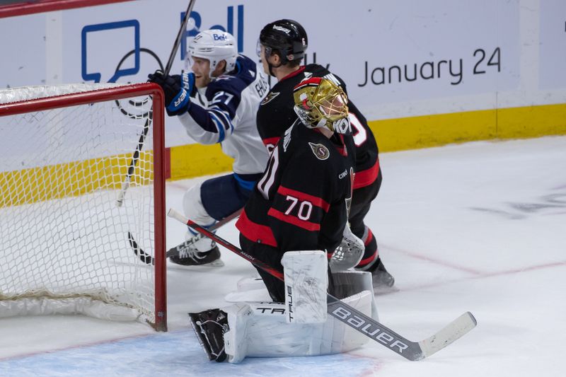 Jan 20, 2024; Ottawa, Ontario, CAN; Winnipeg Jets left wing Nikolaj Ehlers (27) scores against Ottawa Senators goalie Joonas Koprpisalo (70) in overtime at the Canadian Tire Centre. Mandatory Credit: Marc DesRosiers-USA TODAY Sports