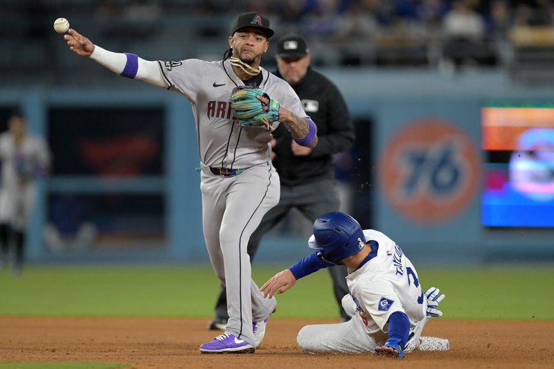 May 20, 2024; Los Angeles, California, USA;  Los Angeles Dodgers left fielder Chris Taylor (3) is out at second as Arizona Diamondbacks second baseman Ketel Marte (4) throws to first for a double play in the eighth inning at Dodger Stadium. Mandatory Credit: Jayne Kamin-Oncea-USA TODAY Sports