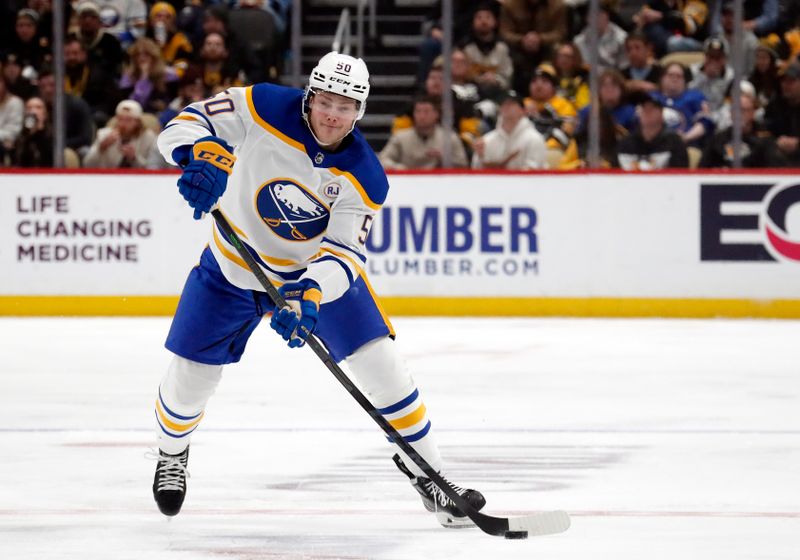 Jan 6, 2024; Pittsburgh, Pennsylvania, USA;  Buffalo Sabres left wing Eric Robinson (50) handles the puck against the Pittsburgh Penguins during the second period at PPG Paints Arena. Mandatory Credit: Charles LeClaire-USA TODAY Sports