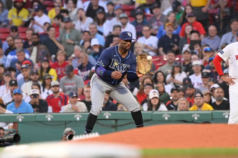 May 14, 2024; Boston, Massachusetts, USA; Tampa Bay Rays first baseman Yandy Diaz (2) makes a catch for an out against the Boston Red Sox during the third inning at Fenway Park. Mandatory Credit: Eric Canha-USA TODAY Sports