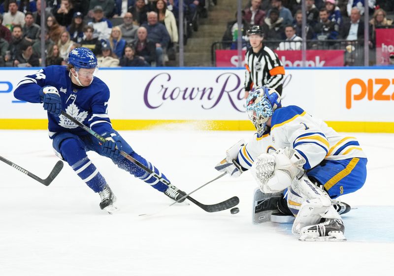 Mar 6, 2024; Toronto, Ontario, CAN; Toronto Maple Leafs center Bobby McMann (74) battles for the puck in front of Buffalo Sabres goaltender Ukko-Pekka Luukkonen (1) during the first period at Scotiabank Arena. Mandatory Credit: Nick Turchiaro-USA TODAY Sports