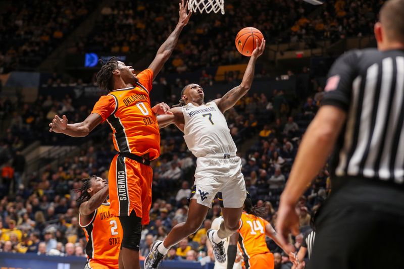 Jan 4, 2025; Morgantown, West Virginia, USA; West Virginia Mountaineers guard Javon Small (7) shoots against Oklahoma State Cowboys forward Marchelus Avery (0) during the first half at WVU Coliseum. Mandatory Credit: Ben Queen-Imagn Images