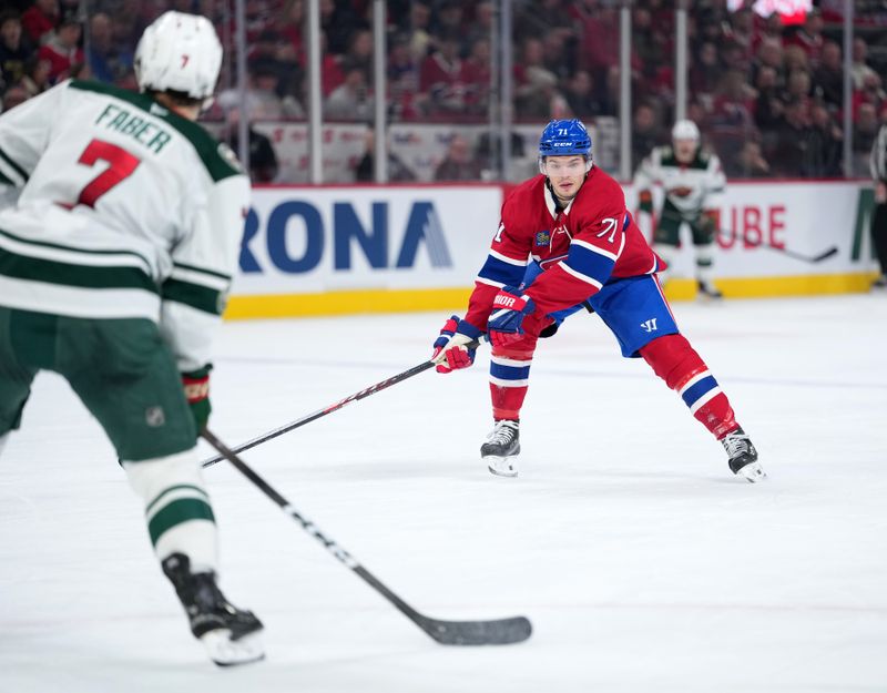 Jan 20, 2026; Montreal, Quebec, CAN; Montreal Canadiens forward Jake Evans (71) forechecks on Minnesota Wild defenseman Brock Faber (7) during the second period at the Bell Centre. Mandatory Credit: Eric Bolte-Imagn Images