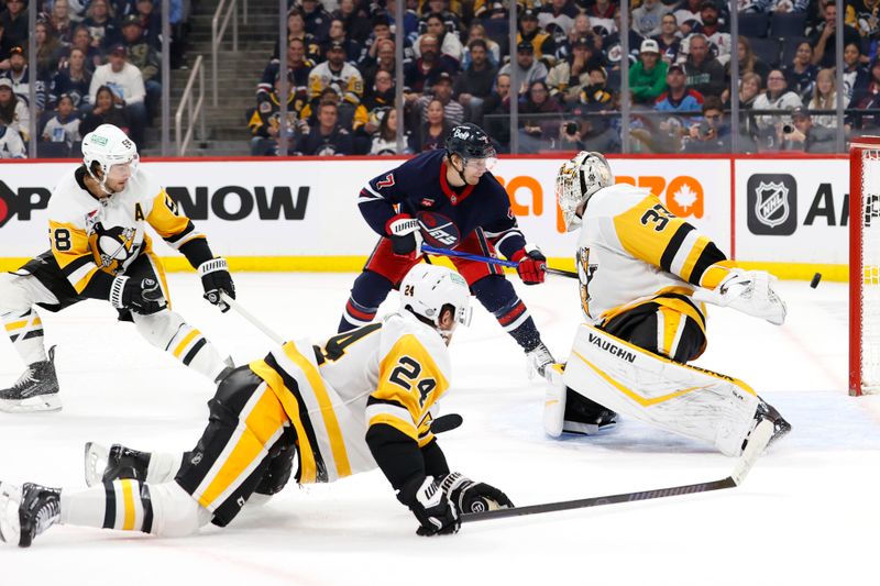 Oct 20, 2024; Winnipeg, Manitoba, CAN; Winnipeg Jets center Vladislav Namestnikov (7) scores on Pittsburgh Penguins goaltender Alex Nedeljkovic (39) in the second period at Canada Life Centre. Mandatory Credit: James Carey Lauder-Imagn Images