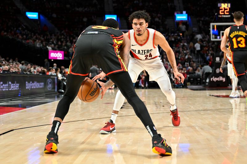 PORTLAND, OREGON - MARCH 13: Justin Minaya #24 of the Portland Trail Blazers defends against Dejounte Murray #5 of the Atlanta Hawks during the second quarter of the game at the Moda Center on March 13, 2024 in Portland, Oregon. (Photo by Alika Jenner/Getty Images)