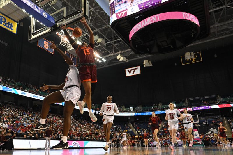 Mar 5, 2023; Greensboro, NC, USA; Virginia Tech Hokies forward Taylor Soule (13) shoots over Louisville Cardinals forward Olivia Cochran (44) during the second half at Greensboro Coliseum. Mandatory Credit: William Howard-USA TODAY Sports