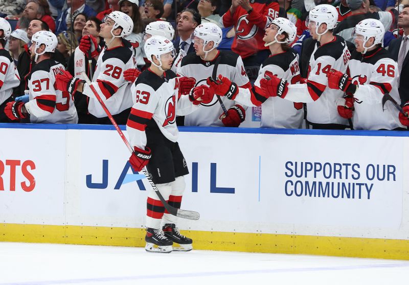 Jan 27, 2024; Tampa, Florida, USA; New Jersey Devils left wing Jesper Bratt (63) is congratulated after he scored a goal against the Tampa Bay Lightning during the third period at Amalie Arena. Mandatory Credit: Kim Klement Neitzel-USA TODAY Sports